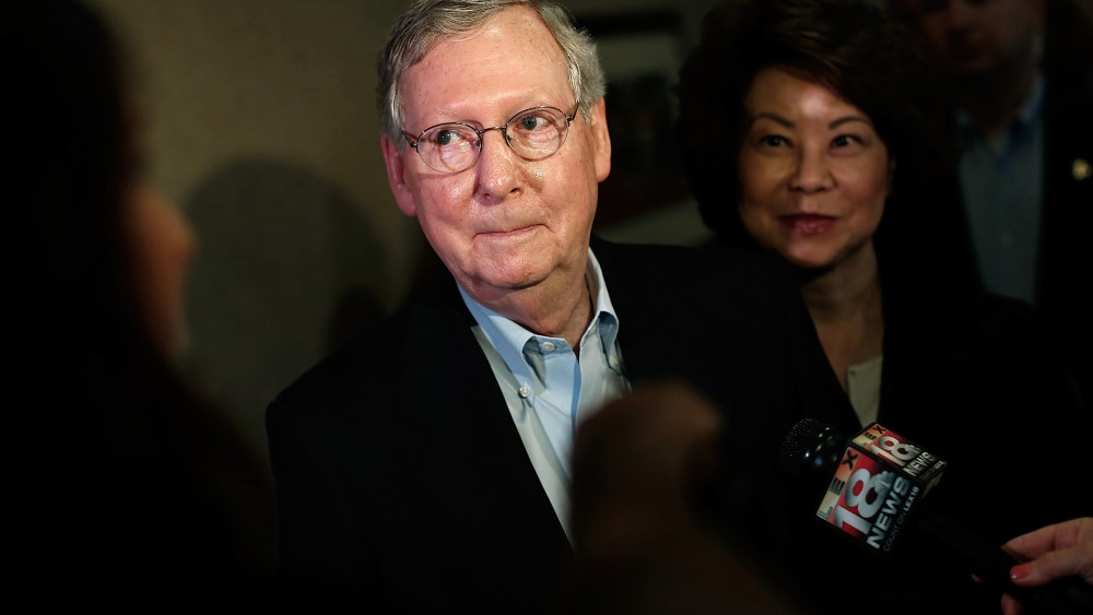 Senate Republican Leader Sen. Mitch McConnell (R-KY) answers questions  while speaking to the press at at a campaign rally with his wife Elaine Chao (R) May 19, 2014 in Louisville, Ky.