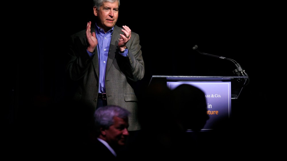 Michigan Governor Rick Snyder applauds during a luncheon May 21, 2014 in Detroit, Michigan. (Photo by Joshua Lott/Getty)