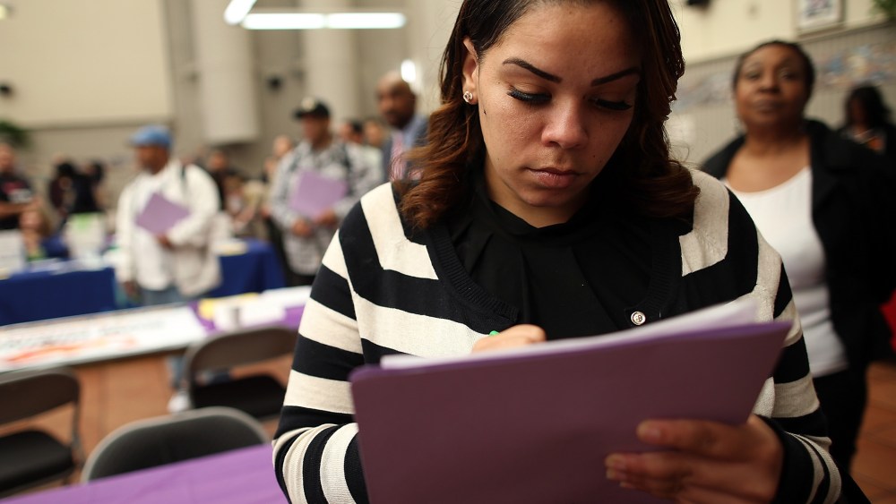 A job seeker fills out an application during a career fair at the Southeast Community Facility Commission on May 21, 2014 in San Francisco, California.