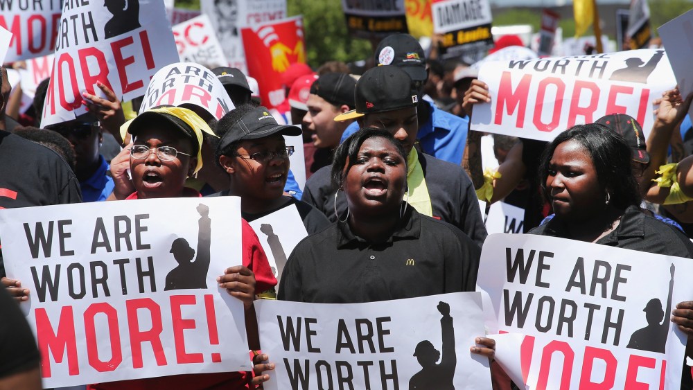 Fast food workers and activists demonstrate outside the McDonald's corporate campus on May 21, 2014 in Oak Brook, Illinois.