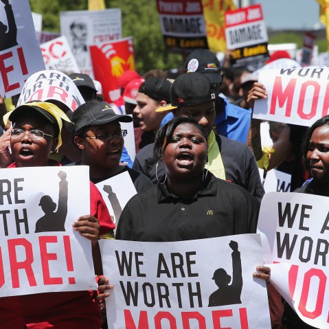 Fast food workers and activists demonstrate outside the McDonald's corporate campus on May 21, 2014 in Oak Brook, Illinois.