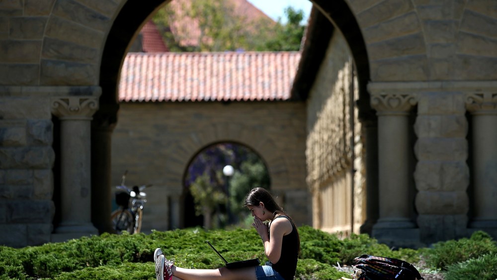 A woman works on a laptop on the Stanford University campus on May 22, 2014 in Stanford, California.