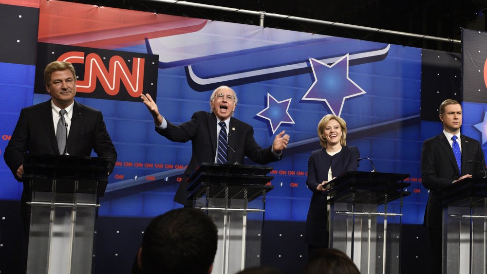 Alec Baldwin as Jim Webb, Larry David as Bernie Sanders, Kate McKinnon as Hillary Clinton, Taran Killam as Martin O'Malley during the "Democratic Debate Cold Open" sketch on Oct. 17, 2015. (Photo by Dana Edelson/NBC/NBCU Photo Bank/Getty)