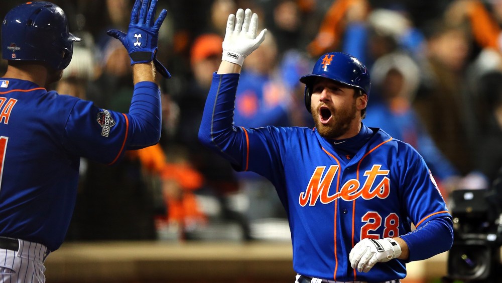 Daniel Murphy #28 of the New York Mets celebrates with his teammates after hitting a two run home run in the first inning against Jake Arrieta #49 of the Chicago Cubs during game two. (Photo by Elsa/Getty)