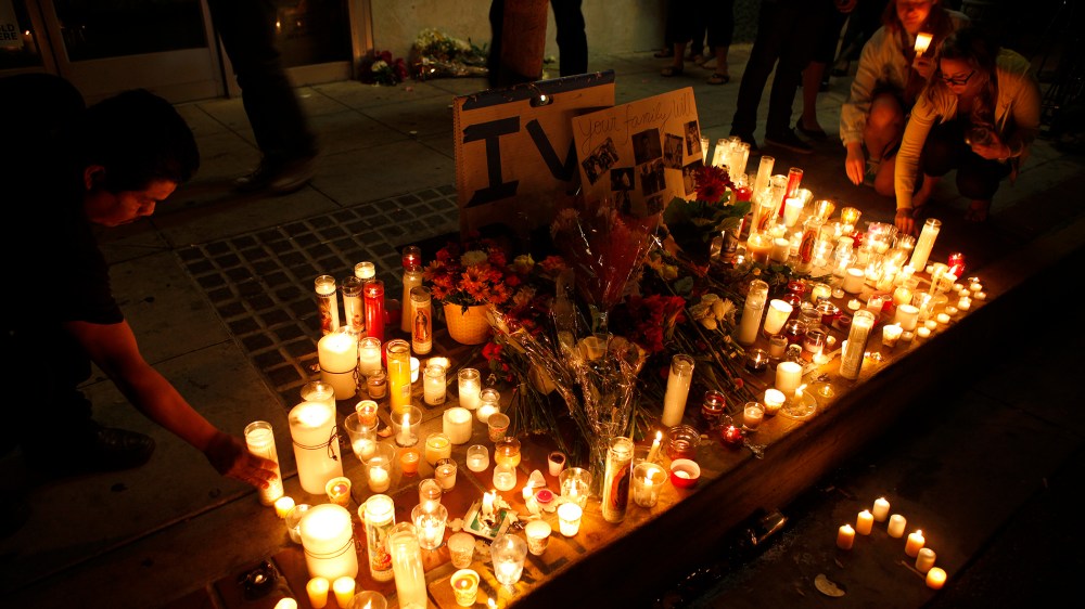 People leave candles and flowers at a growing memorial in front of the IV Deli Mart on Pardall Road in Isla Vista on May 24, 2014 in Santa Barbara, California.