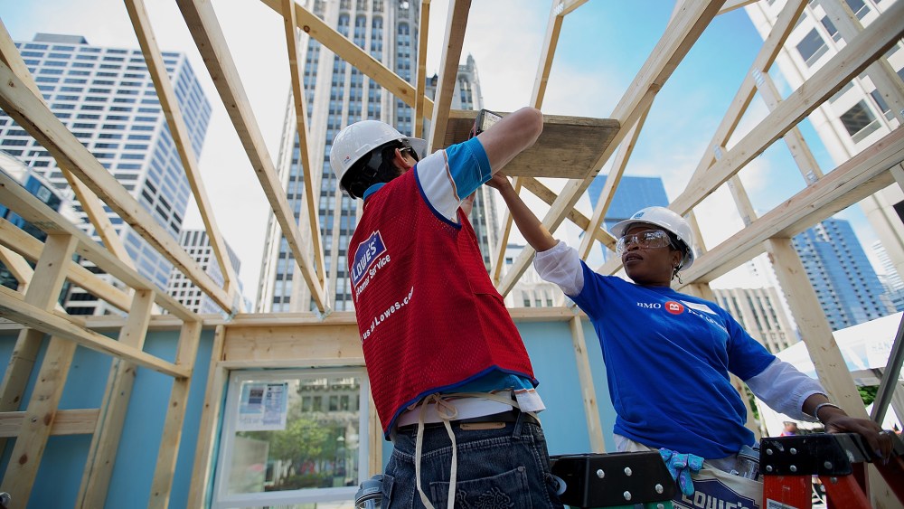 Volunteers erect a Habitat for Humanity home in Chicago, Ill., as part of an unprecedented building blitz in the heart of downtown Chicago. (Photo by Jeff Schear/Getty for Habitat For Humanity)