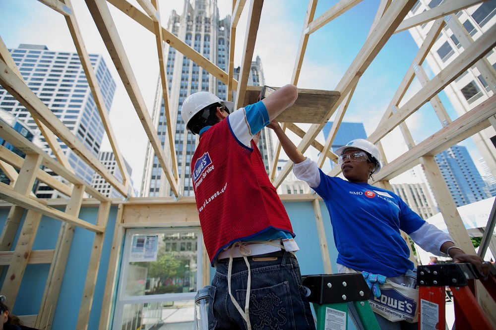 Volunteers erect a Habitat for Humanity home in Chicago, Ill., as part of an unprecedented building blitz in the heart of downtown Chicago. (Photo by Jeff Schear/Getty for Habitat For Humanity)