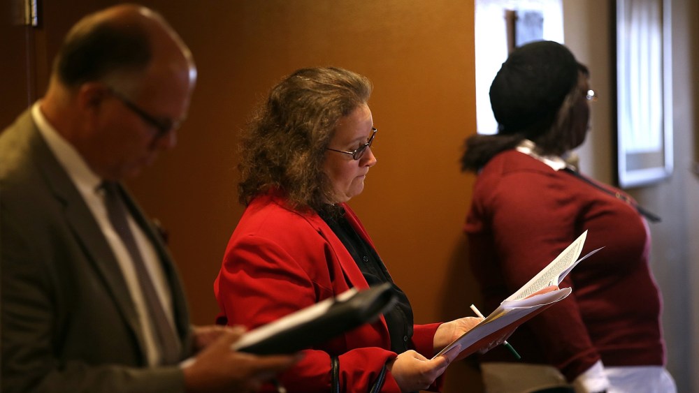 Job seekers fill out applications before the start of the HireLive career fair on June 4, 2014 in San Francisco, Calif.