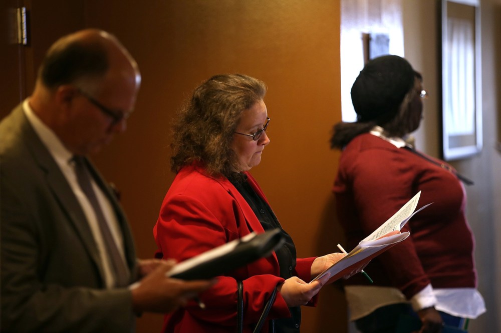 Job seekers fill out applications before the start of the HireLive career fair on June 4, 2014 in San Francisco, Calif.
