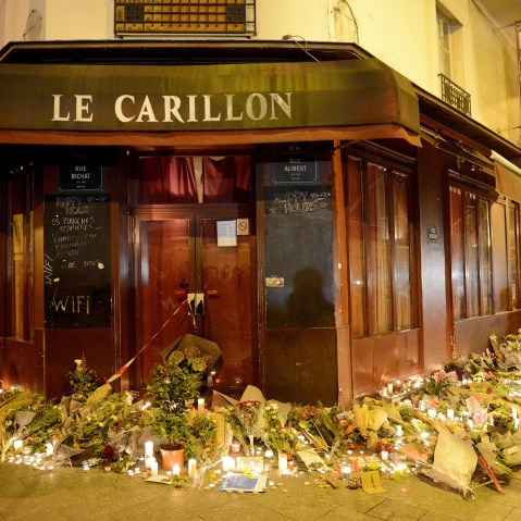 Flowers and candles are placed outside Le Carillon bar, the day after a deadly attack on Nov. 14, 2015 in Paris, France. (Photo by Antoine Antoniol/Getty)