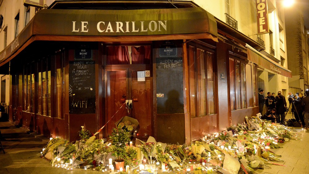 Flowers and candles are placed outside Le Carillon bar, the day after a deadly attack on Nov. 14, 2015 in Paris, France. (Photo by Antoine Antoniol/Getty)