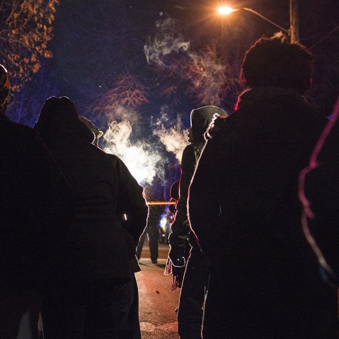A group gathers in front of a police line after 5 people were shot at a Black Lives Matters protest Nov. 24, 2015 in Minneapolis, Minn. (Photo by Stephen Maturen/Getty)