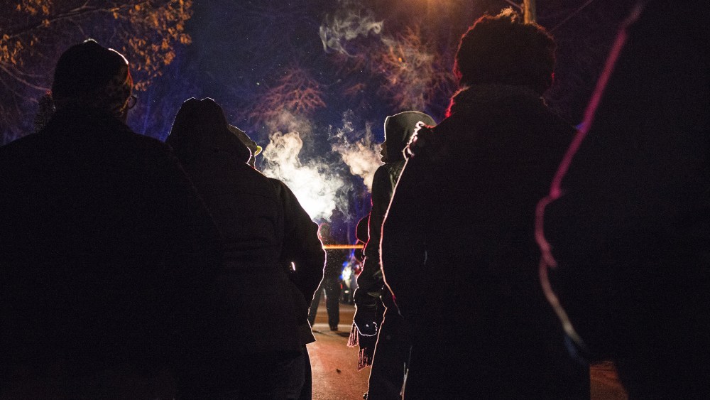A group gathers in front of a police line after 5 people were shot at a Black Lives Matters protest Nov. 24, 2015 in Minneapolis, Minn. (Photo by Stephen Maturen/Getty)