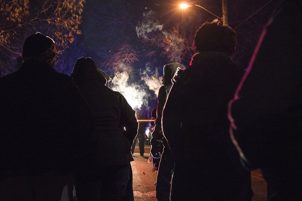 A group gathers in front of a police line after 5 people were shot at a Black Lives Matters protest Nov. 24, 2015 in Minneapolis, Minn. (Photo by Stephen Maturen/Getty)