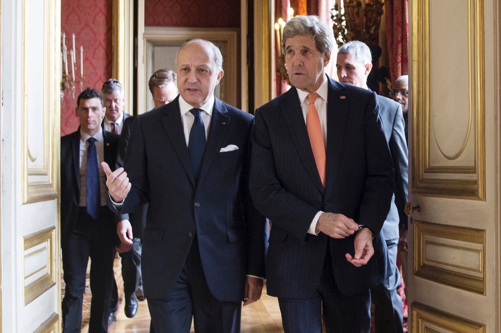 French Foreign Affairs Minister Laurent Fabius (L) and U.S. Secretary of State John Kerry speak as they arrive for a meeting at the French Foreign Affairs Ministry in Paris on March 7, 2015. (Photo by Etienne Laurent/Pool/Reuters)