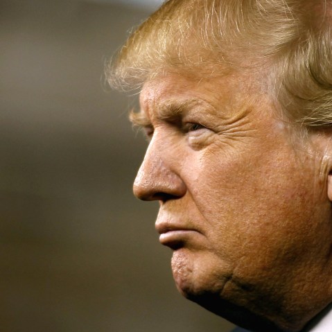 Republican presidential candidate Donald Trump peers out into the crowd during a campaign event at the International Air Response facility on Dec. 16, 2015 in Mesa, Ariz. (Photo by Ralph Freso/Getty)