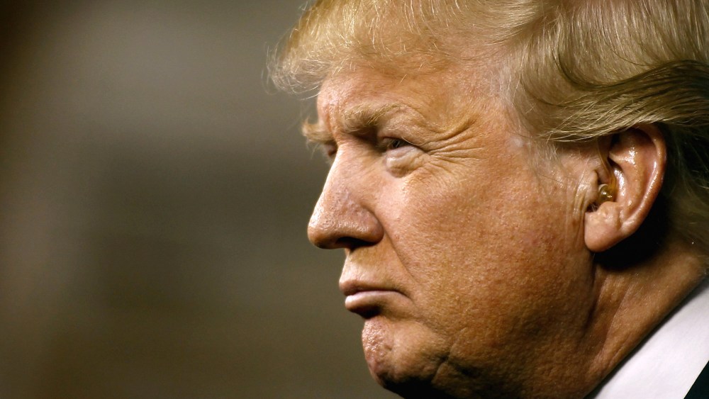 Republican presidential candidate Donald Trump peers out into the crowd during a campaign event at the International Air Response facility on Dec. 16, 2015 in Mesa, Ariz. (Photo by Ralph Freso/Getty)