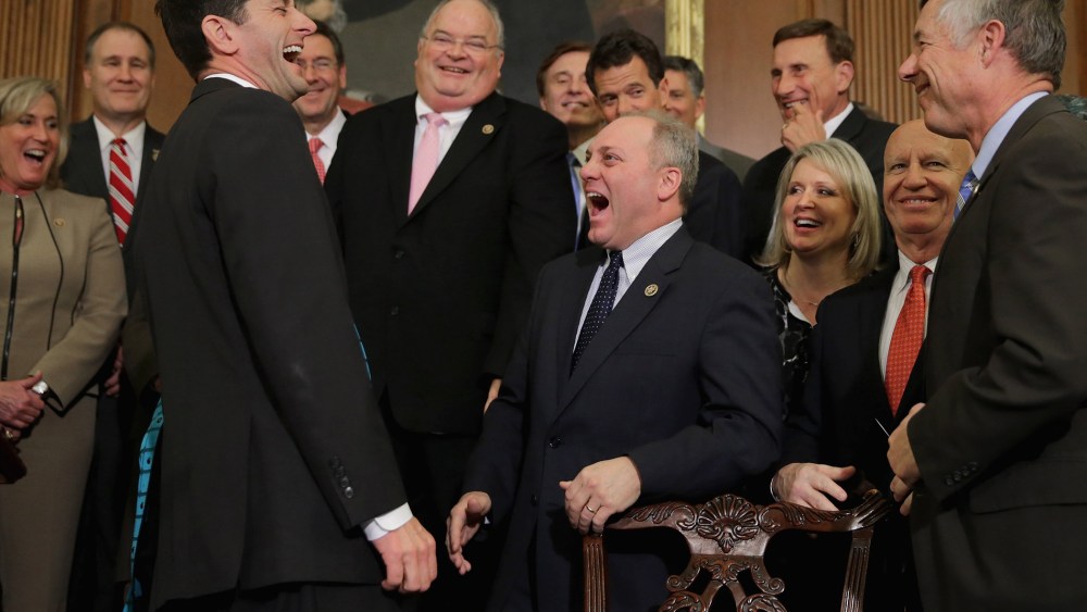 Speaker of the House Paul Ryan shares a laugh with Republican members of Congress after signing legislation to repeal the Affordable Care Act, also known as Obamacare, and to cut off federal funding of Planned Parenthood.