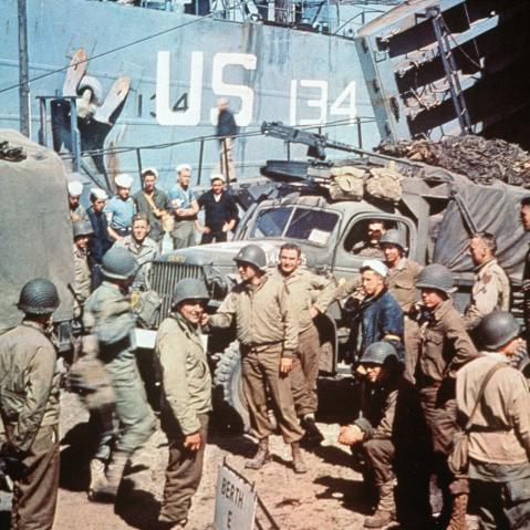 US soldiers gather around trucks disembarking from landing crafts shortly after Allied forces stormed the Normandy beaches, June 6, 1944.