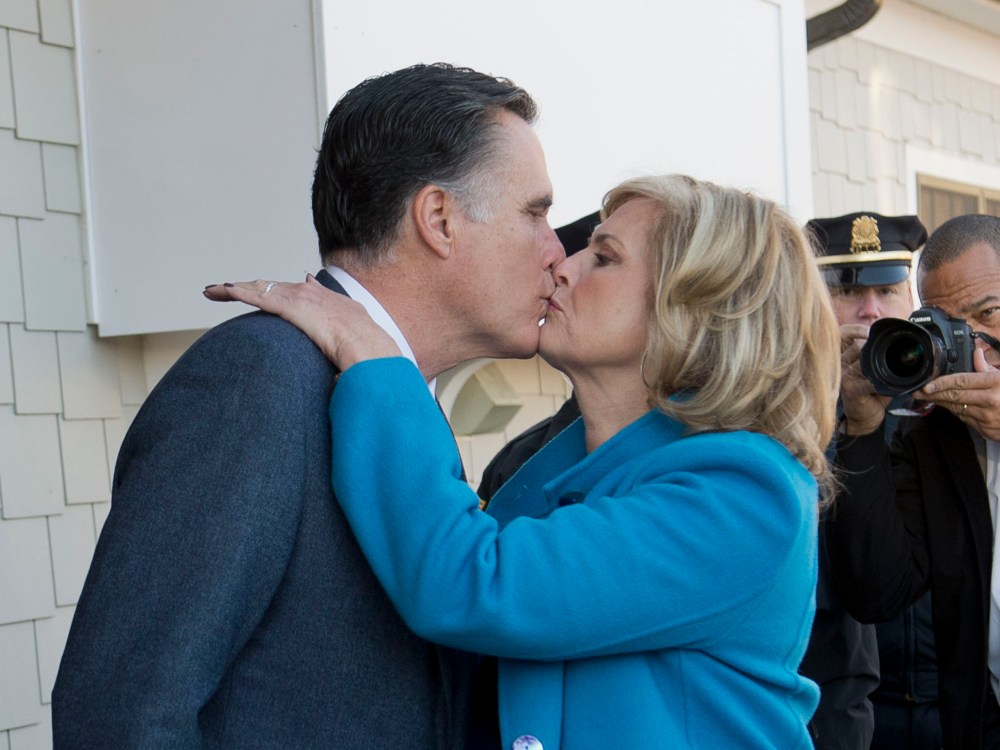 presidential candidate Mitt Romney and his wife Ann kiss after casting their votes in the US presidential elections in Belmont, Massachusetts, November 6, 2012. (Photo by Emmanuel Dunand/AFP/Getty Images)