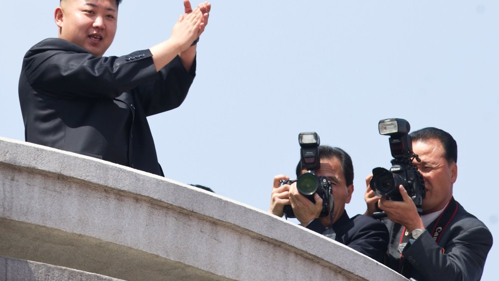 File photo: North Korean leader Kim Jong-Un (L) applauds during a military parade in honour of the 100th birthday of the late North Korean leader Kim Il-Sung in Pyongyang on April 15, 2012.  (Photo by Ed Jones/AFP/Getty Images file)