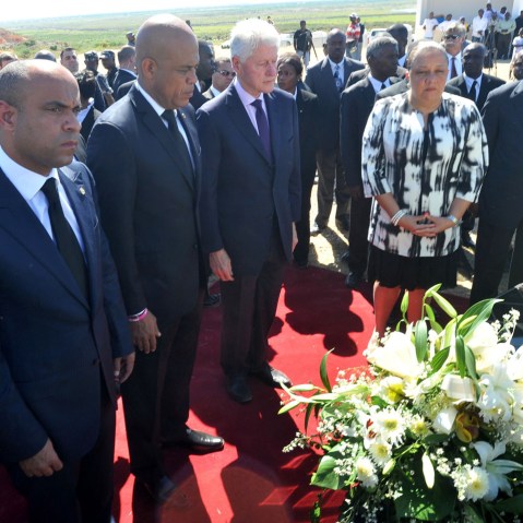 Haitian Prime Minister Laurent Lamorthe, Haitian President Michel Martelly, UN special envoy to Haiti former US president Bill Clinton and Haitian First Lady Sophia Martelly observe a minute of silence on January 12, 2013 in Titanyin, 14km from Port-au...