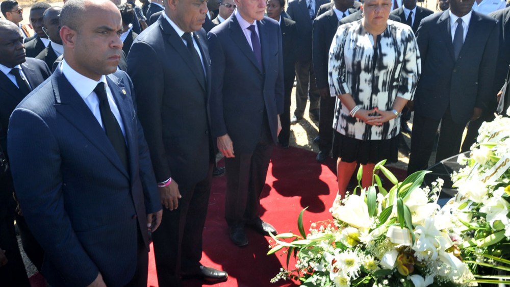 Haitian Prime Minister Laurent Lamorthe, Haitian President Michel Martelly, UN special envoy to Haiti former US president Bill Clinton and Haitian First Lady Sophia Martelly observe a minute of silence on January 12, 2013 in Titanyin, 14km from Port-au...