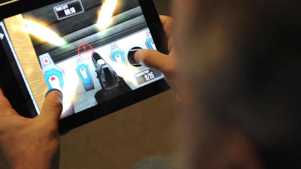 This January 15, 2013 photo taken in Washington, DC, shows a man playing the newly released National Rifle Association (NRA) iPhone/iPad app, "NRA: Practice Range." The new app was released January 14, by the nation's largest gun-industry lobby. The...