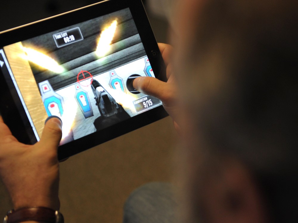 This January 15, 2013 photo taken in Washington, DC, shows a man playing the newly released National Rifle Association (NRA) iPhone/iPad app, "NRA: Practice Range." The new app was released January 14, by the nation's largest gun-industry lobby. The...