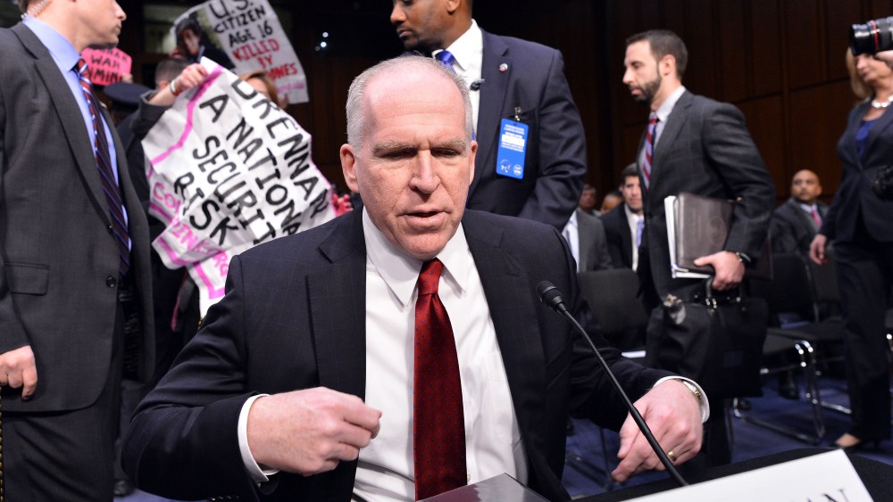 Anti-war protesters shout slogans as John Brennan (R), President Barack Obama's pick to lead the CIA, arrives to testify before a full committee hearing on his nomination to be director of the Central Intelligence Agency  (CIA) in the Hart Senate...