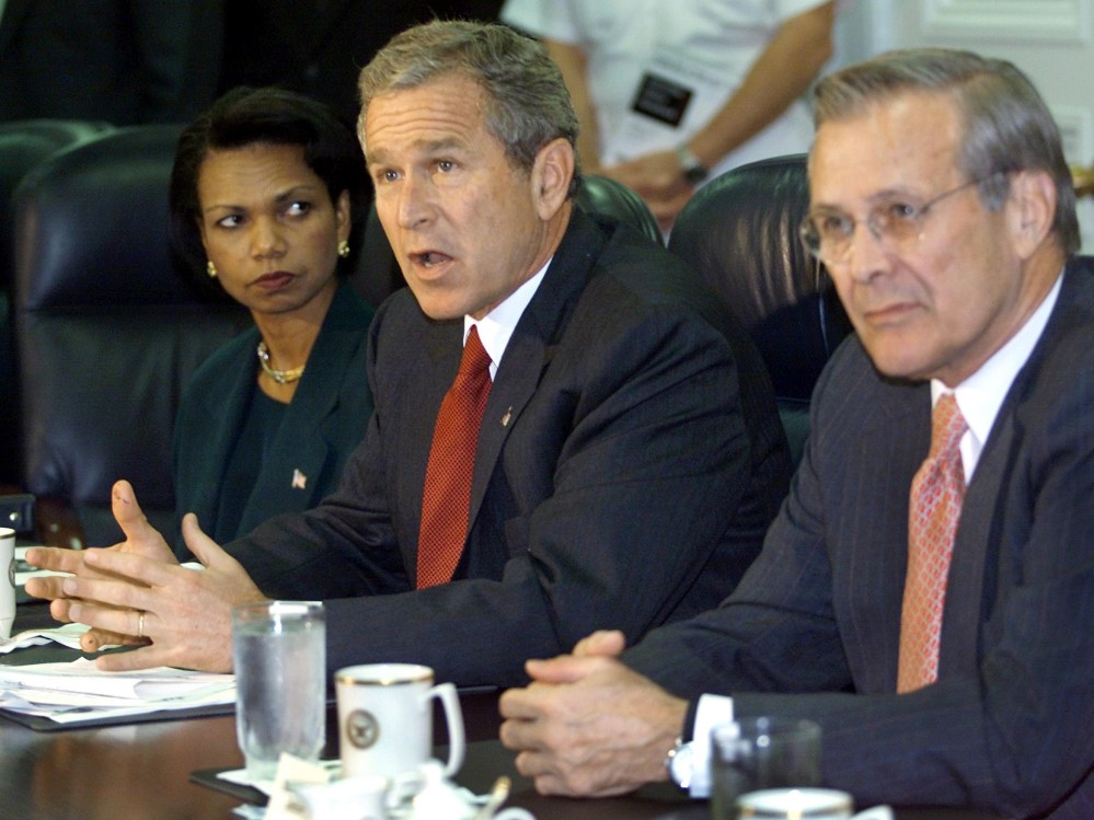 File Photo: US President George W. Bush (C) answers questions from the media as US National Security Adviser Condoleezza Rice (L) and US Secretary of Defense Donald Rumsfeld (R) look on during a meeting with military leaders at the Pentagon 17...