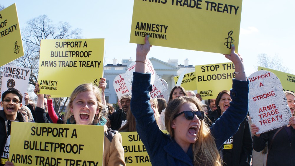 Amnesty International protestors demonstrate outside of the White House in Washington, DC, on March 22, 2013.  The protestors were urging President Obama to support a bulletproof Arms Trade Treaty. Photo by Nicole Sakin/AFP/Getty Images)