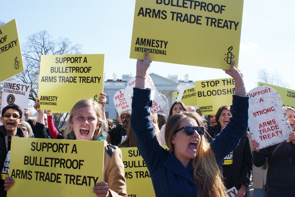 Amnesty International protestors demonstrate outside of the White House in Washington, DC, on March 22, 2013.  The protestors were urging President Obama to support a bulletproof Arms Trade Treaty. Photo by Nicole Sakin/AFP/Getty Images)