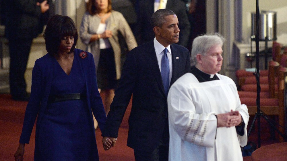 President Barack Obama and first lady Michelle Obama arrive at the "Healing Our City: An Interfaith Service" dedicated to those who were gravely wounded or killed in the Boston Marathon bombing, at the Cathedral of the Holy Cross in Boston,...