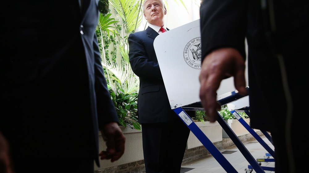 Security agents stand close as Republican Presidential candidate Donald Trump votes at his local polling station in New York's primary on April 19, 2016 in New York City. (Photo by Spencer Platt/Getty)