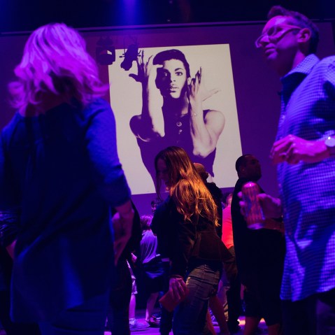 Guests dance to Prince music as a slide show flashes images of the artist above the stage during a memorial dance party at the First Avenue nightclub on April 21, 2016 in Minneapolis, Minn. (Photo by Scott Olson/Getty)