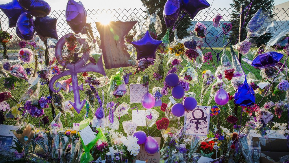 Mementos left by fans are attached to the fence which surrounds Paisley Park, the home and studio of Prince, on April 23, 2016 in Chanhassen, Minn. (Photo by Scott Olson/Getty)