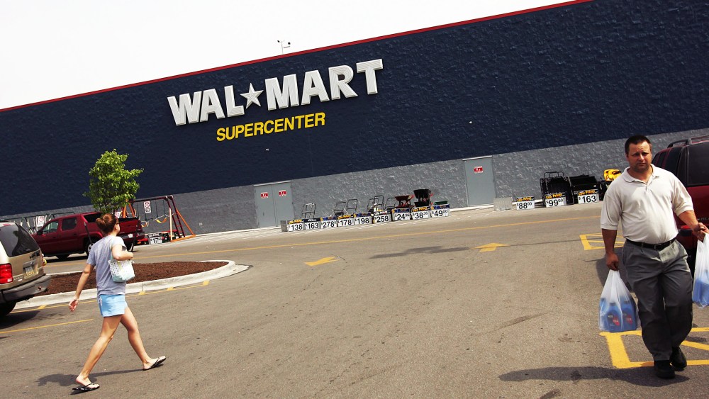 Shoppers walk in the parking lot of a Wal-Mart Supercenter in Troy, Ohio.