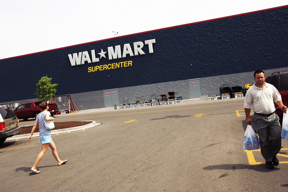 Shoppers walk in the parking lot of a Wal-Mart Supercenter in Troy, Ohio.
