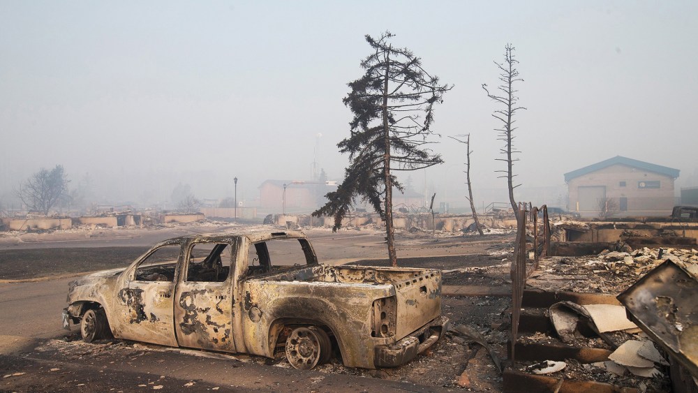 Home foundations and shells of vehicles are nearly all that remain in a residential neighborhood destroyed by a wildfire on May 6, 2016 in Fort McMurray, Alberta, Canada. (Photo by Scott Olson/Getty)