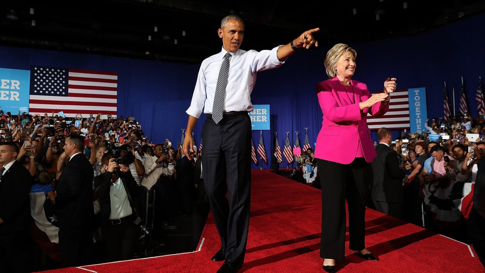 Democratic presidential candidate former Secretary of State Hillary Clinton (R) and U.S. president Barack Obama greet supporters during a campaign rally on July 5, 2016 in Charlotte, N.C. (Photo by Justin Sullivan/Getty)