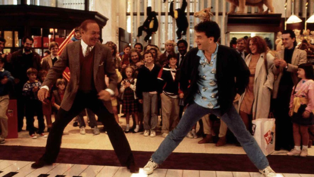 Robert Loggia, left, and Tom Hanks stand on a giant piano keyboard at the FAO Schwartz toy store in a still from the film 'Big' directed by Penny Marshall. (Photo by United Archives/ullstein bild/Getty)