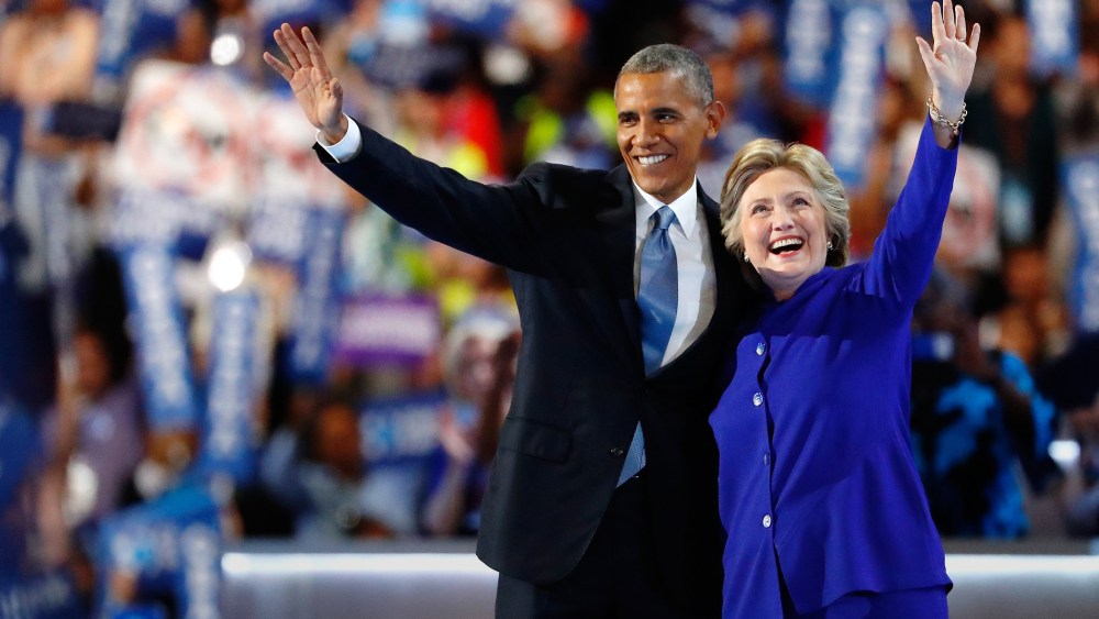 President Barack Obama and Democratic presidential candidate Hillary Clinton wave to the crowd at the Democratic National Convention, July 27, 2016 in Philadelphia, Penn. (Photo by Aaron P. Bernstein/Getty)