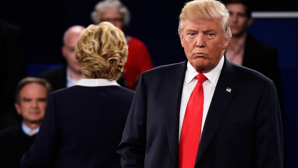 Democratic presidential nominee Hillary Clinton and Republican presidential nominee Donald Trump listen to a question during the town hall debate at Washington University on Oct 9, 2016 in St Louis, Mo. (Photo by Saul Loeb/Pool/Getty)