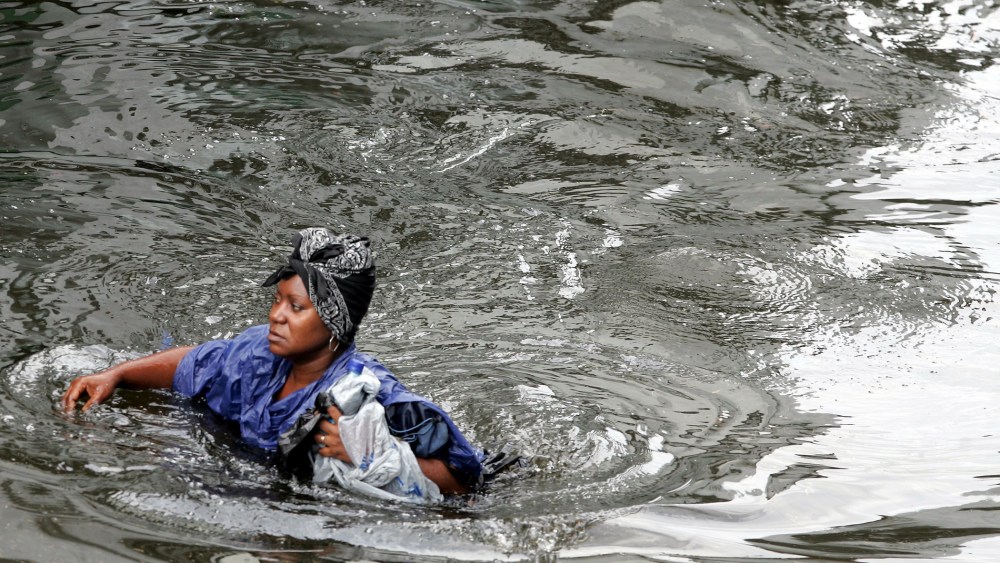A woman walks through chest-deep floodwater from actual Hurricane Katrina in New Orleans, August 30, 2005.