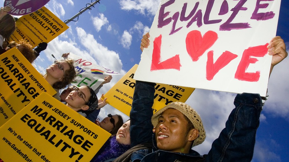 File Photo: Supporters await the New Jersey Supreme court decision on same-sex marriage in front of the Supreme court building on  October 25, 2006 in Trenton, New Jersey. New Jersey's highest court guaranteed gay couples the same rights as married...