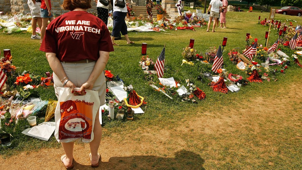 People walk along the edge of a memorial for the victims of the shooting at Virginia Tech, May 11, 2007, in Blacksburg, Virginia.