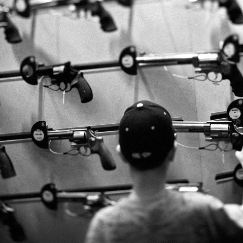 An attendee looks at a display of guns during one of the National Rifle Association's (NRA) Annual Meetings.