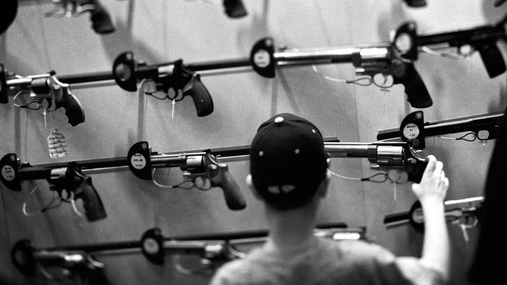 An attendee looks at a display of guns during one of the National Rifle Association's (NRA) Annual Meetings.
