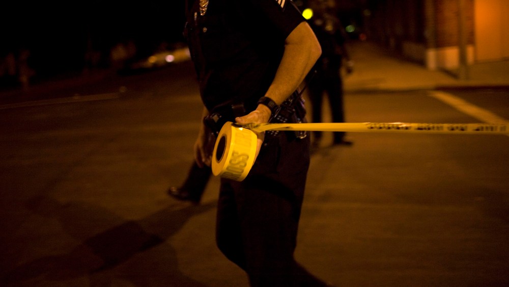 Los Angeles Police Department officers tape off a Crime Scene Investigation area.